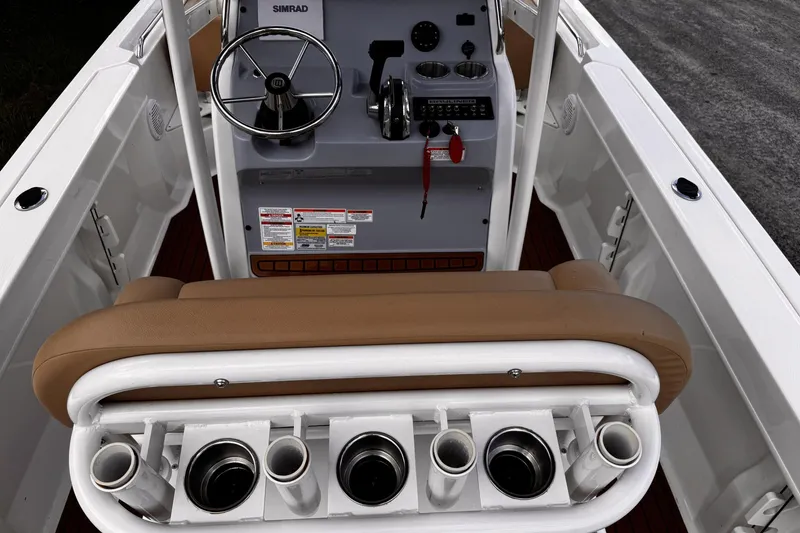 Slide: The Image of 2023 Bayliner Trophy T20CC boat cockpit with steering wheel and rod holders. - 27