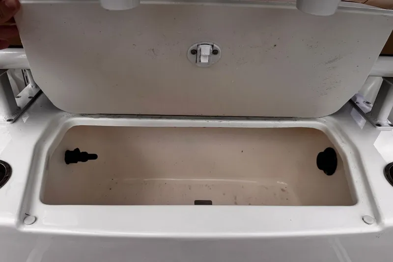 Slide: The Image of 2023 Bayliner Trophy T20CC storage compartment with open lid, showcasing interior space. - 29