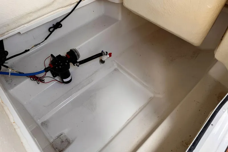 Slide: The Image of 2023 Bayliner Trophy T20CC interior compartment with wiring and pump system. - 30