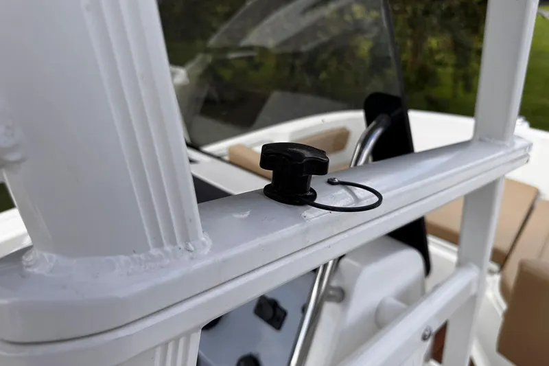 Slide: The Image of 2023 Bayliner Trophy T20CC boat detail with black knob and white railing. - 32