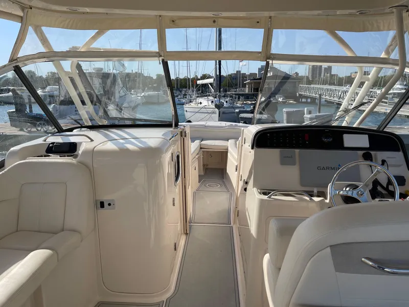 Slide: The Image of 2016 Grady-White Freedom 335 boat interior with helm, docked at marina. - 12
