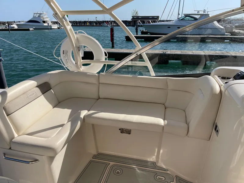 Slide: The Image of 2016 Grady-White Freedom 335 boat interior with beige seating, docked at marina. - 14