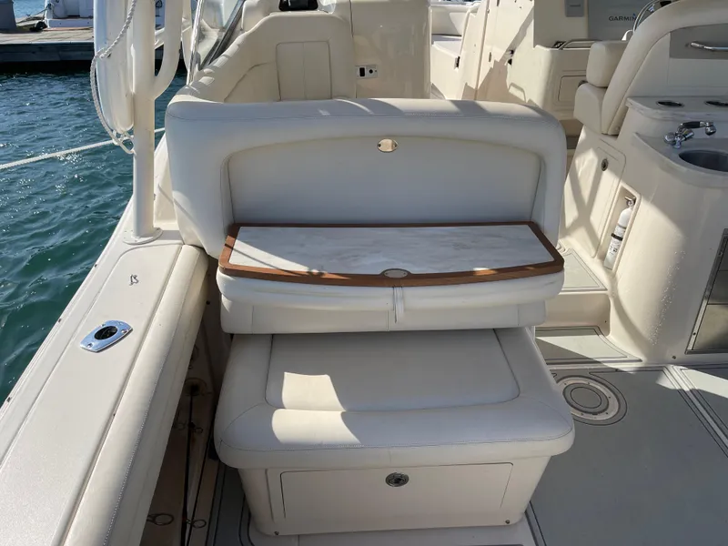 Slide: The Image of 2016 Grady-White Freedom 335 boat interior with cushioned seating and storage. - 17
