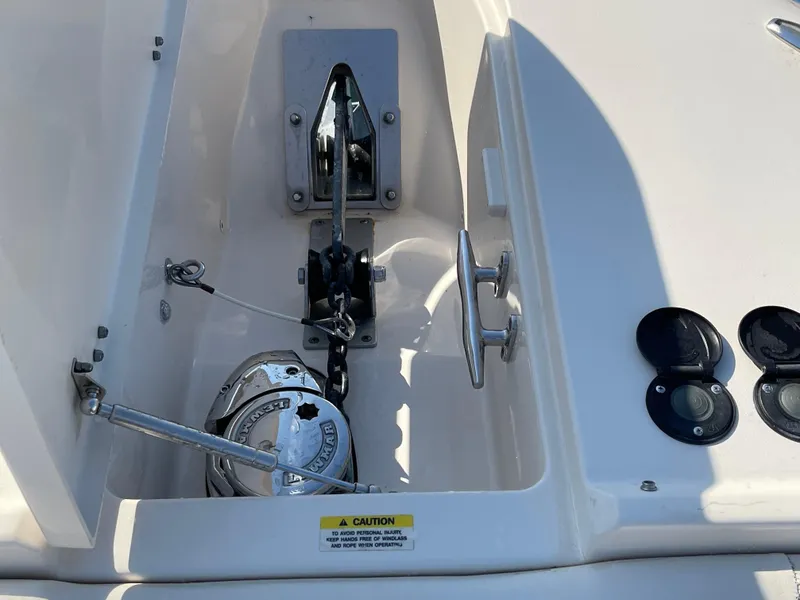 Slide: The Image of Anchor compartment of 2016 Grady-White Freedom 335 boat, featuring winch and controls. - 19