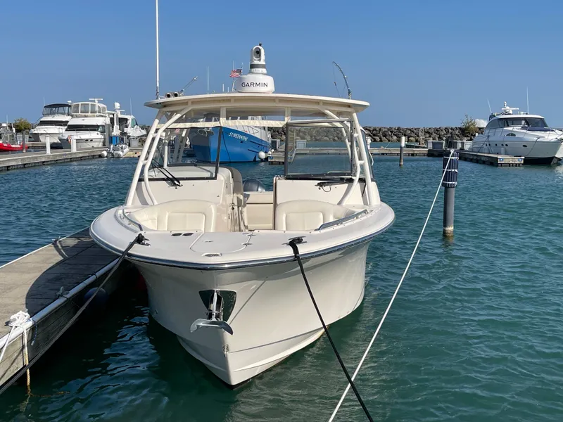 Slide: The Image of 2016 Grady-White Freedom 335 boat docked in marina, clear blue sky. - 2