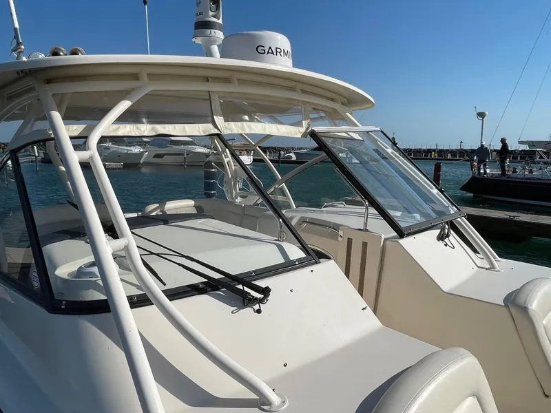 Slide: The Image of 2016 Grady-White Freedom 335 boat docked at marina, featuring Garmin equipment. - 22