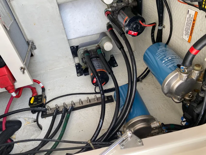 Slide: The Image of Engine compartment of a 2016 Grady-White Freedom 335 boat, showing wiring and components. - 24