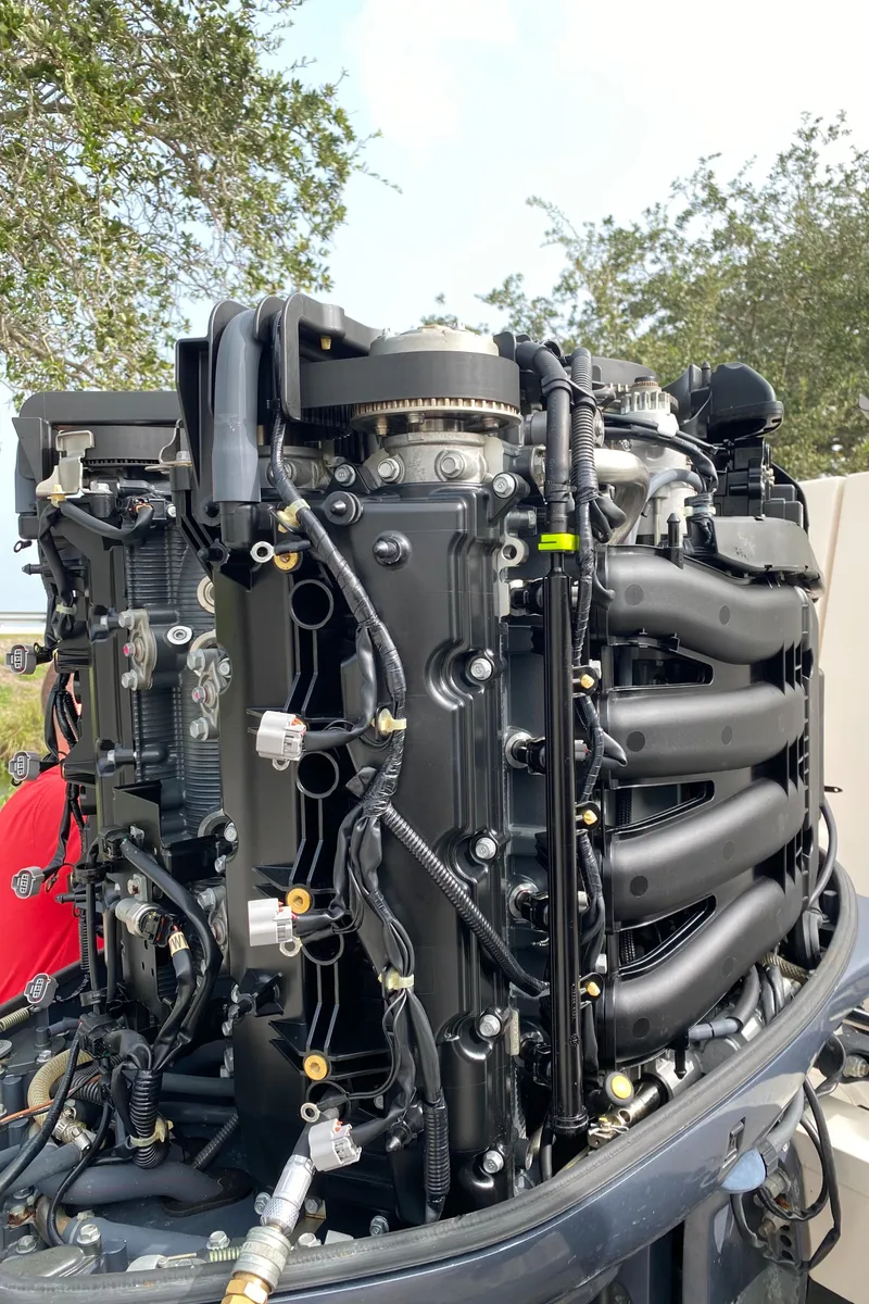 Slide: The Image of Close-up of a 2016 Grady-White Freedom 335 boat engine, showcasing intricate mechanical details. - 26