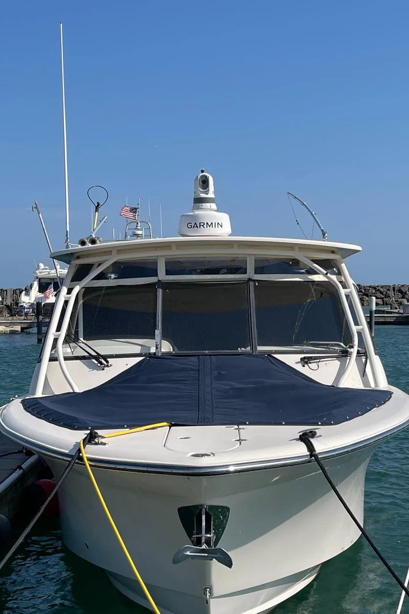 Slide: The Image of 2016 Grady-White Freedom 335 boat docked in marina, featuring Garmin equipment. - 27