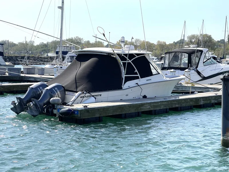 Slide: The Image of 2016 Grady-White Freedom 335 boat docked in marina with twin engines. - 3