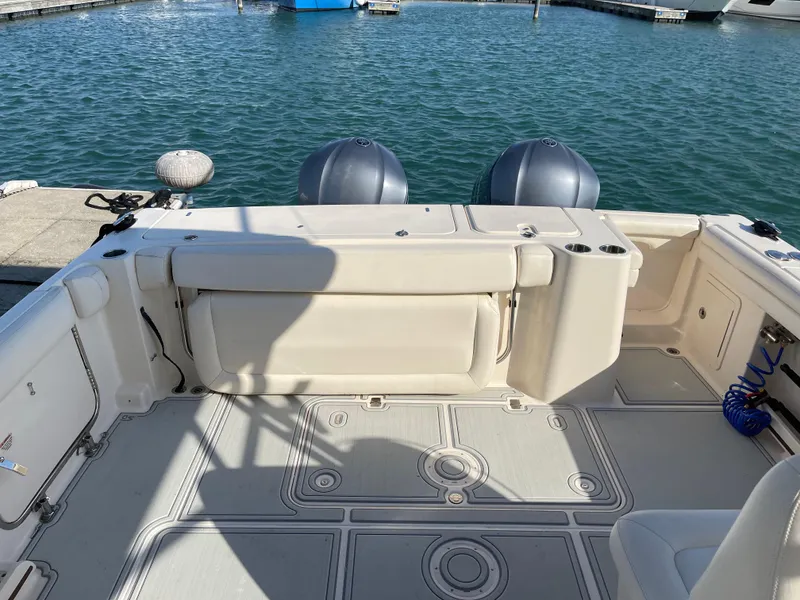 Slide: The Image of 2016 Grady-White Freedom 335 boat deck with twin engines at marina. - 9