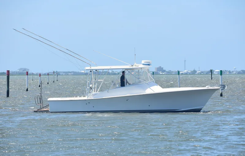 Slide: The Image of 2004 Judge 34 Express boat cruising on a sunny day in open waters. - 5