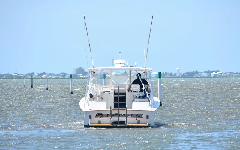 Slide: The Image of 2004 Judge 34 Express boat navigating coastal waters on a sunny day. - 8