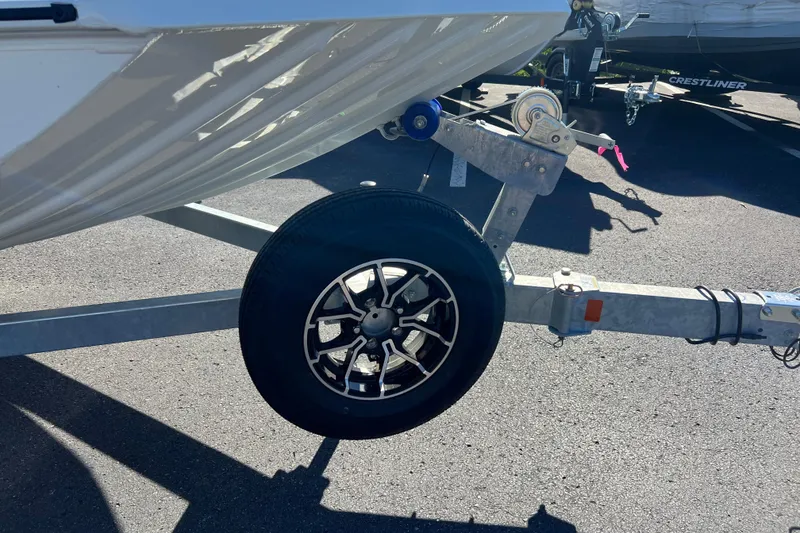 Slide: The Image of Trailer wheel of 2026 Crestliner 1870 Retriever FCC boat on asphalt. - 3