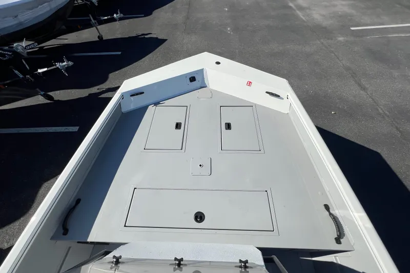 Slide: The Image of 2026 Crestliner 1870 Retriever FCC boat deck with storage compartments, parked on asphalt. - 4