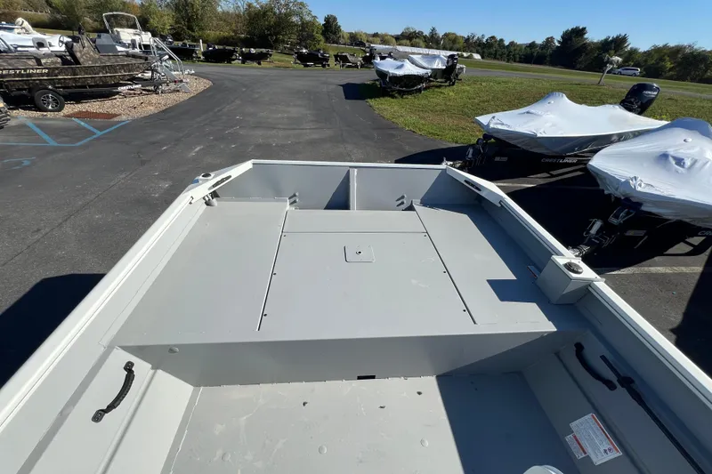 Slide: The Image of 2026 Crestliner 1870 Retriever FCC boat on display in a parking lot. - 9