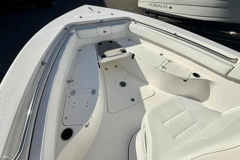 Slide: The Image of 2022 Sea Pro 239 Center Console boat interior with seating and storage compartments. - 11