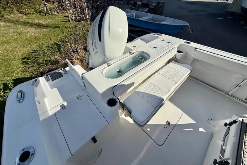 Slide: The Image of 2022 Sea Pro 239 Center Console boat interior with seating and storage features. - 14