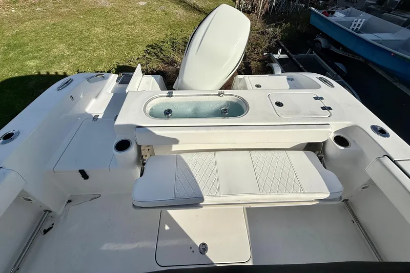 Slide: The Image of 2022 Sea Pro 239 Center Console boat interior with seating and storage compartments. - 15