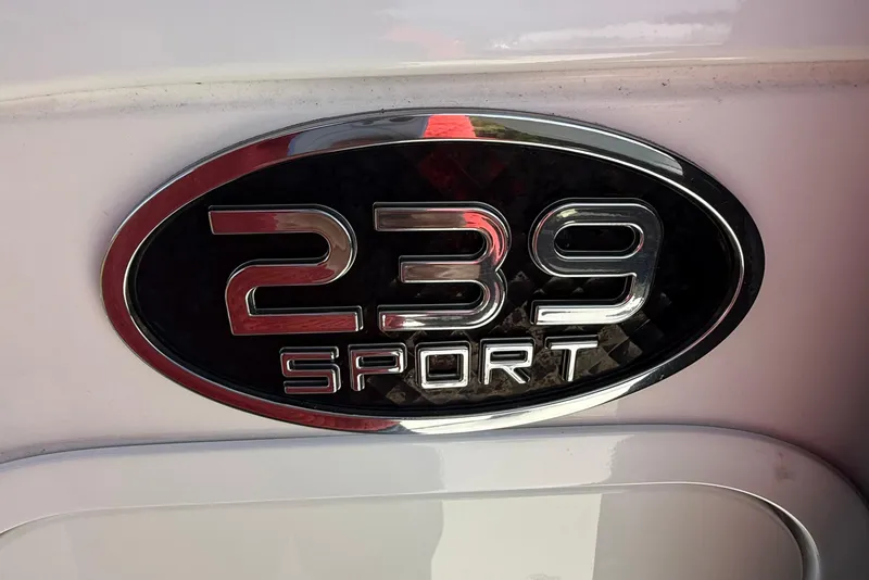 Slide: The Image of Chrome emblem of 2022 Sea Pro 239 Center Console boat on white surface. - 17