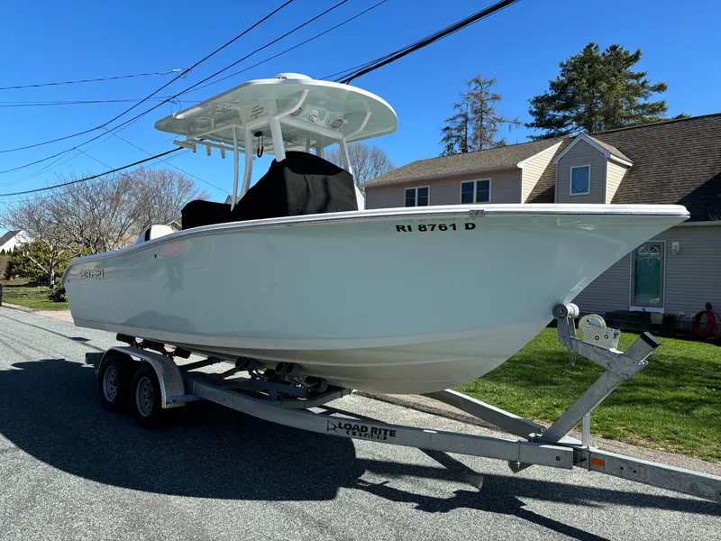 Slide: The Image of 2022 Sea Pro 239 Center Console boat on trailer, parked in residential area. - 3