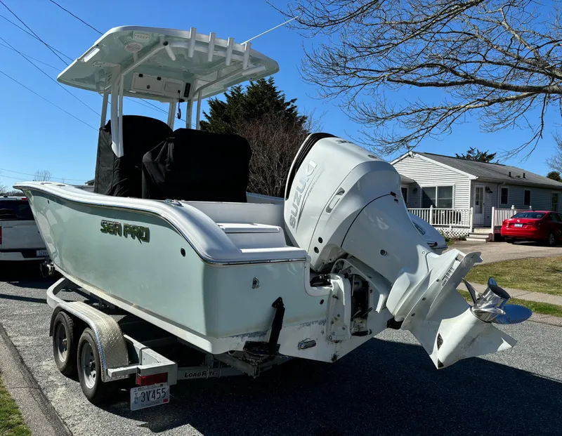Slide: The Image of 2022 Sea Pro 239 Center Console boat on trailer, parked in residential area. - 4