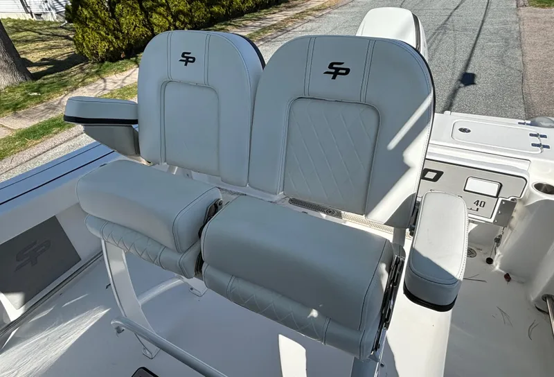 Slide: The Image of 2022 Sea Pro 239 Center Console boat seats with logo, featuring white cushioned design. - 8