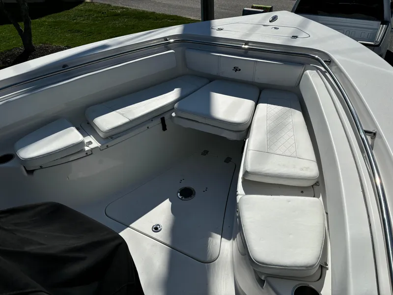 Slide: The Image of 2022 Sea Pro 239 Center Console boat with white cushioned seating in the bow area. - 9