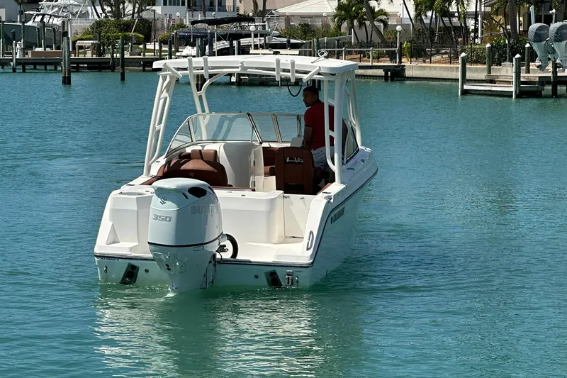 Slide: The Image of 2019 Century 24 Resorter boat with Suzuki 350 engine in a marina setting. - 11