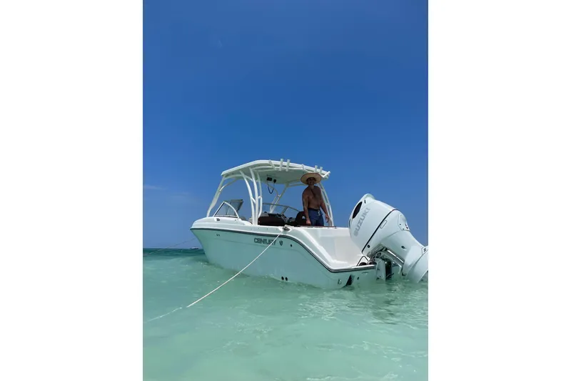 Slide: The Image of 2019 Century 24 Resorter boat in clear water, with a person onboard under a sunny sky. - 20