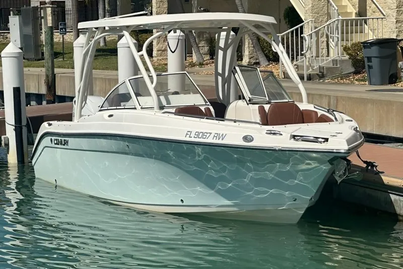 Slide: The Image of 2019 Century 24 Resorter boat docked in clear water, featuring sleek design and modern amenities. - 21