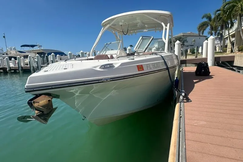 Slide: The Image of 2019 Century 24 Resorter boat docked at marina under clear blue sky. - 22