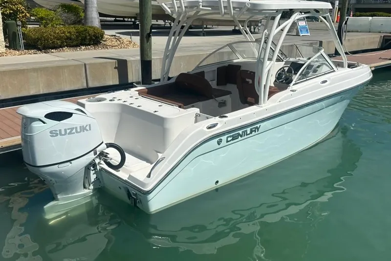 Slide: The Image of 2019 Century 24 Resorter boat with Suzuki outboard motor docked in marina. - 23