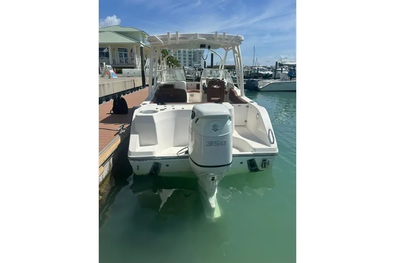 Slide: The Image of 2019 Century 24 Resorter boat docked with Suzuki 350 outboard engine. - 24
