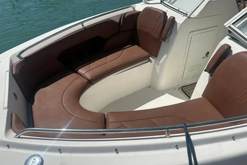 Slide: The Image of 2019 Century 24 Resorter boat with brown seating, docked on calm water. - 25