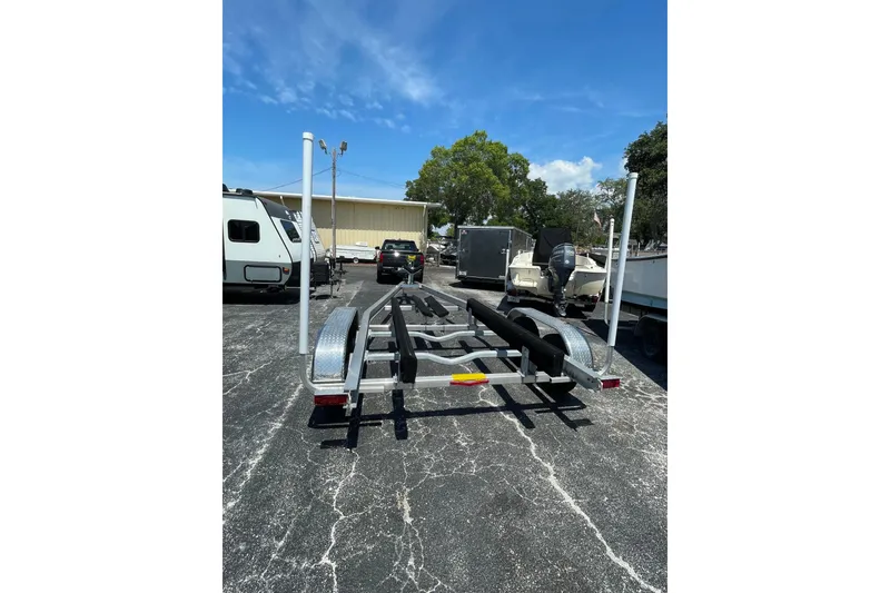 Slide: The Image of Trailer for 2019 Century 24 Resorter boat in parking lot under blue sky. - 33