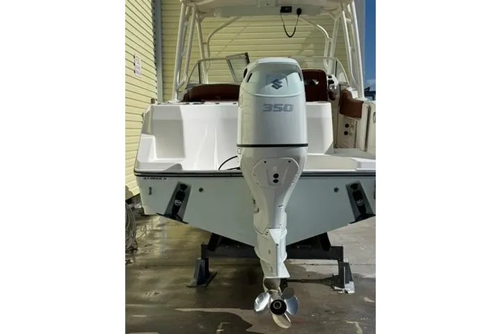 Slide: The Image of 2019 Century 24 Resorter boat with Suzuki 350 outboard motor, docked outdoors. - 39