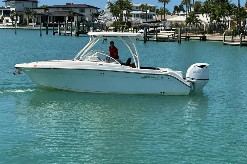 Slide: The Image of 2019 Century 24 Resorter boat cruising in a marina with turquoise water. - 5