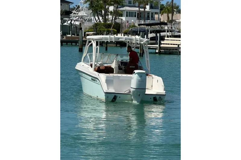 Slide: The Image of 2019 Century 24 Resorter boat cruising in a marina with clear blue water. - 8