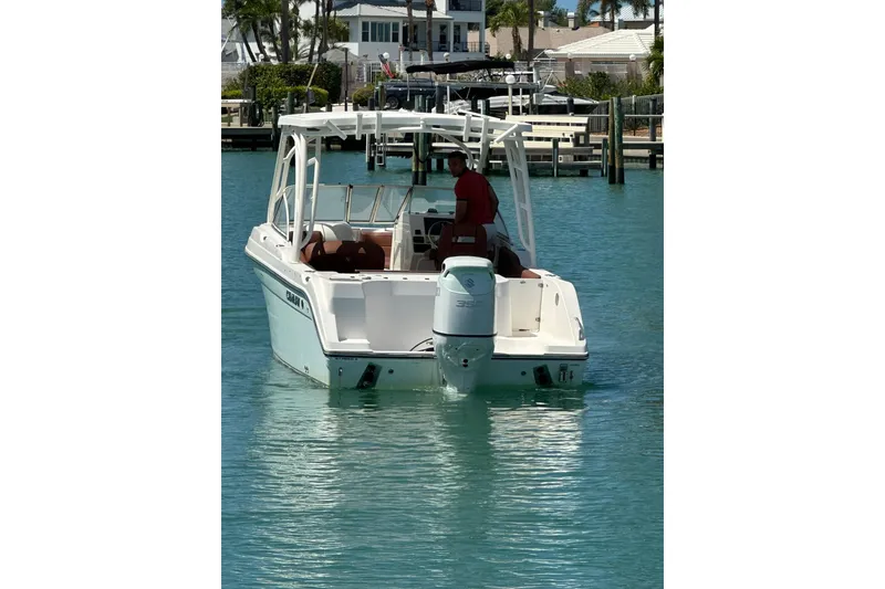 Slide: The Image of 2019 Century 24 Resorter boat on clear blue water near a dock. - 9