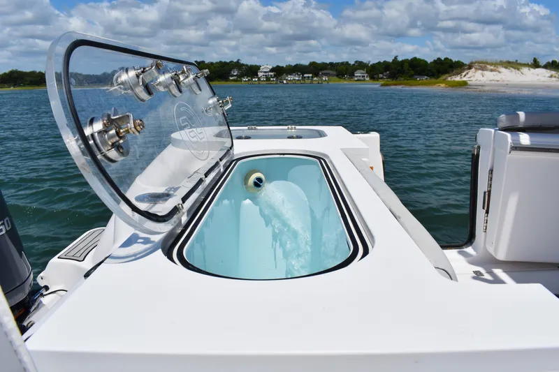 Slide: The Image of 2020 Sea Fox 288 Commander boat with open livewell, ocean view in background. - 30