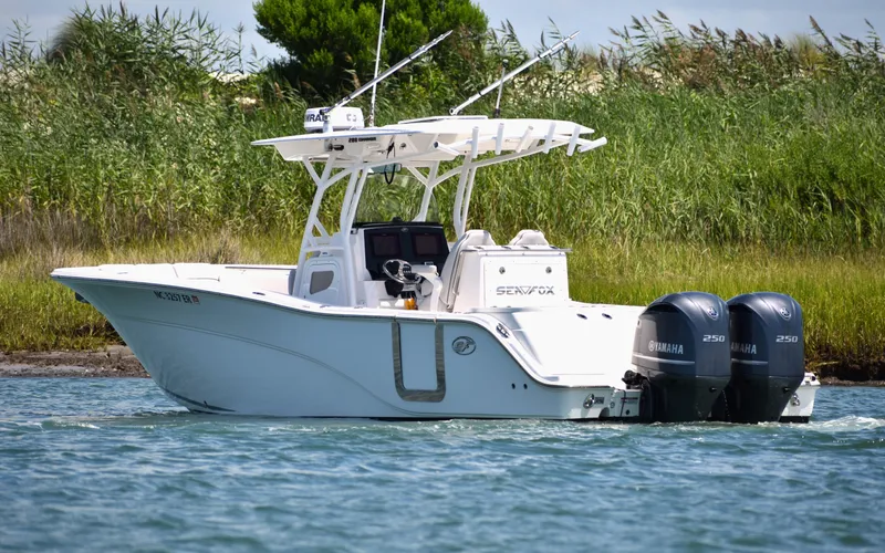 Slide: The Image of 2020 Sea Fox 288 Commander boat with dual Yamaha engines on a calm waterway. - 7