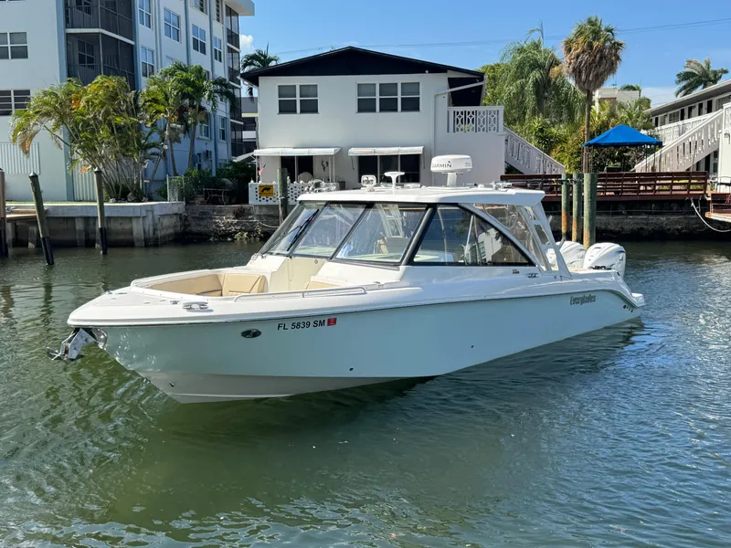 The Image of 2019 Everglades 340 Dual Console boat docked near waterfront homes. - 0