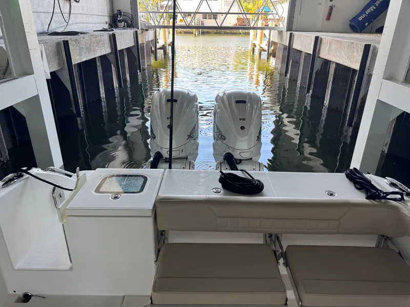Slide: The Image of 2019 Everglades 340 Dual Console boat with twin outboard engines in a marina. - 17