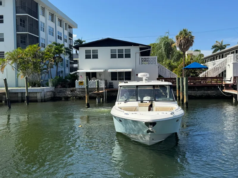 Slide: The Image of 2019 Everglades 340 Dual Console boat docked near waterfront home. - 34