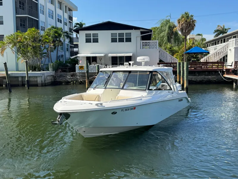 Slide: The Image of 2019 Everglades 340 Dual Console boat docked near waterfront homes. - 36