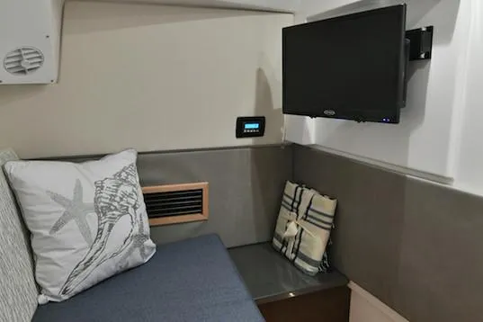 Slide: The Image of Manufacturer Provided Image: Interior cabin of 2019 Everglades 340 Dual Console with TV and seating area. - 42