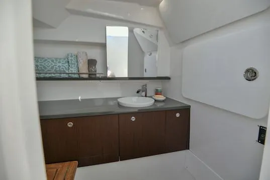 Slide: The Image of Manufacturer Provided Image: 2019 Everglades 340 Dual Console boat bathroom with modern sink and storage cabinets. - 43