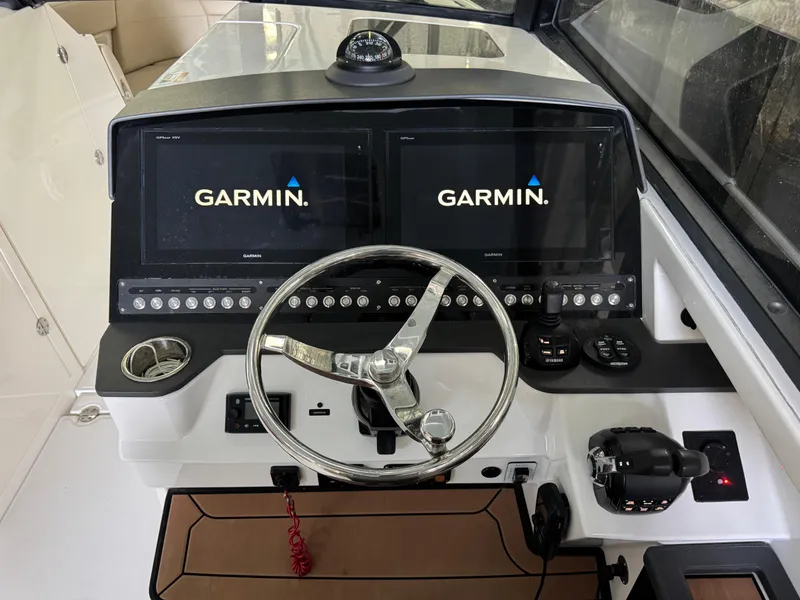 Slide: The Image of 2019 Everglades 340 Dual Console boat dashboard with Garmin navigation displays. - 7