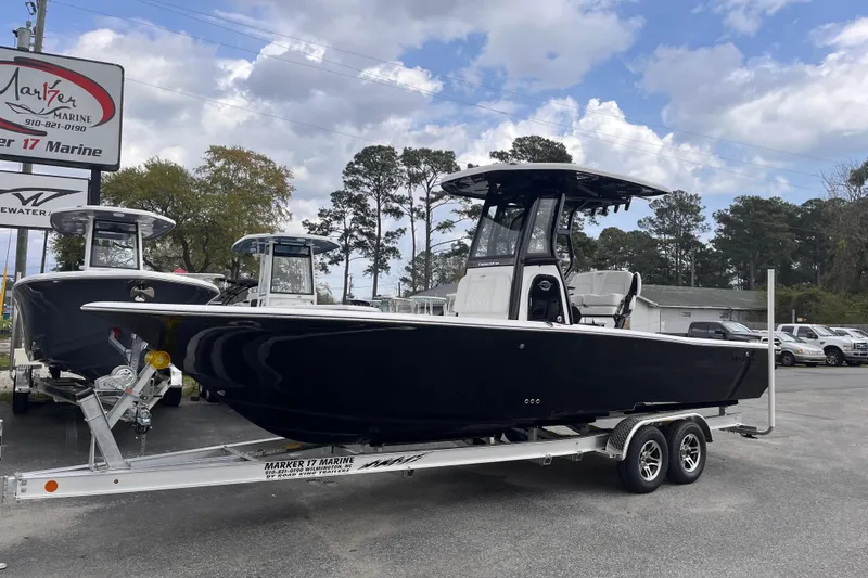 Slide: The Image of 2026 Tidewater 2500 Carolina Bay boat on trailer at marine dealership. - 1